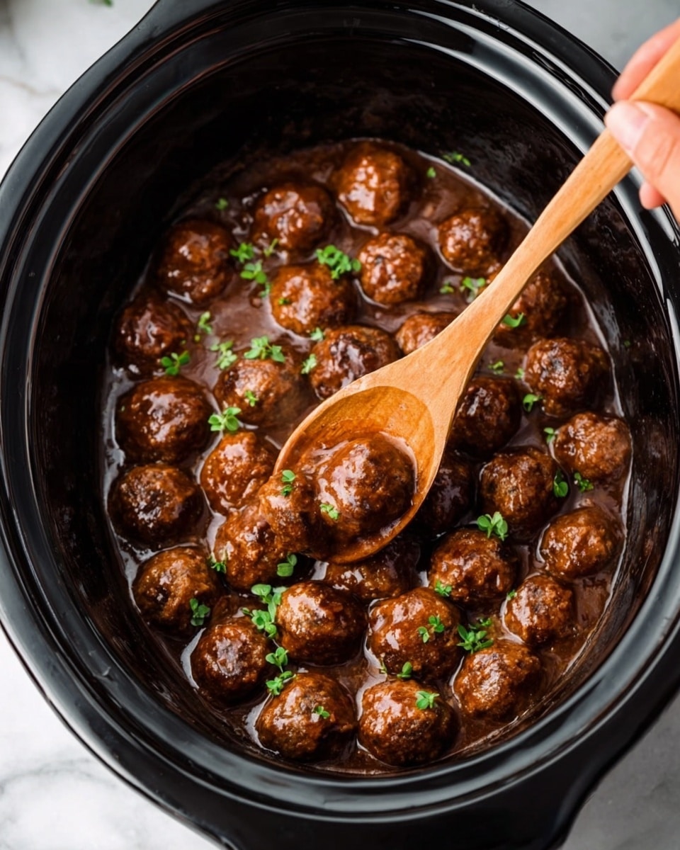 The image shows a black slow cooker filled with many round meatballs in a thick brown sauce. Each meatball is shiny and coated evenly with the sauce, which looks smooth and rich. Small green herbs are sprinkled on top, adding a bit of color contrast to the brown meatballs. A woman’s hand is holding a wooden spoon, scooping some of the meatballs carefully from the slow cooker. The slow cooker is placed on a white marbled surface. photo taken with an iphone --ar 4:5 --v 7