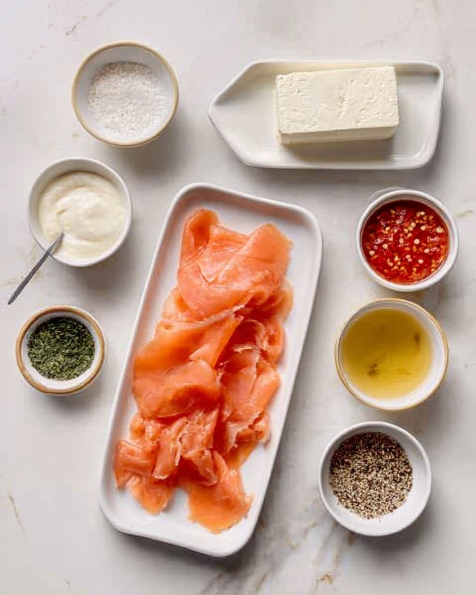The image shows a white rectangular plate with thin slices of orange smoked salmon neatly arranged in loose folds near the bottom right. Above the salmon is a white rectangular block of cream cheese, smooth with a slight shine. Surrounding the plate on a white marbled surface are five small white bowls holding different ingredients: creamy thick sauce in the top left, bright red sauce with visible chili flakes next to it, dried green herbs below the red sauce, a pale yellow liquid to the left below the creamy sauce, and coarse black and white pepper mix on the right. The overall look is clean and organized. Photo taken with an iphone --ar 4:5 --v 7
