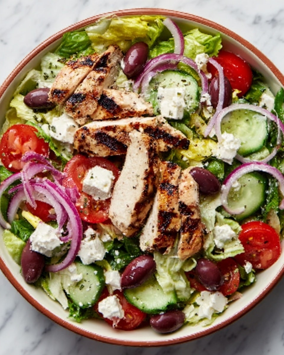 A white bowl holds a colorful salad with three grilled pieces of chicken, placed in the center and on top of the greens. The salad base is made of leafy lettuce and sliced cucumber, with bright red tomato wedges and thin slices of red onion scattered around. Dark purple olives are spread evenly, adding contrast. The salad is topped with small white feta cheese cubes. The bowl is set on a white marbled surface. photo taken with an iphone --ar 4:5 --v 7