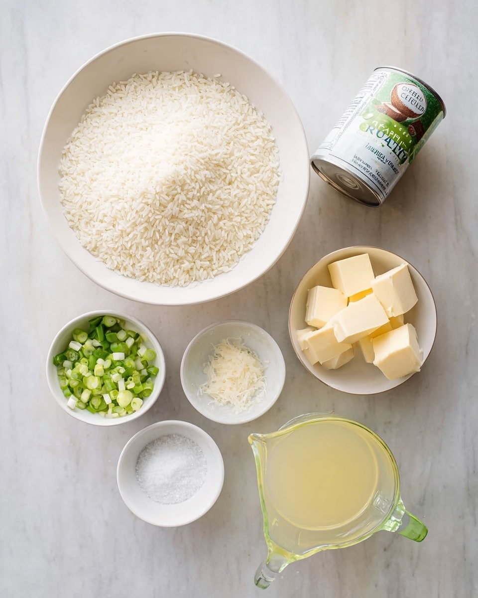 The image shows cooking ingredients arranged on a white marbled surface. There is one large white bowl filled with dry white rice grains positioned at the top left. Below it and slightly to the right, there are three small white bowls: one containing chopped green onions with white and green parts mixed, another with three blocks of pale yellow butter, and the last holding a small amount of white salt. To the right of these bowls is a can of organic coconut milk tilted slightly on its side. Next to the can, on the far right, there is a clear glass measuring cup with a green handle filled with a light yellow liquid. photo taken with an iphone --ar 4:5 --v 7