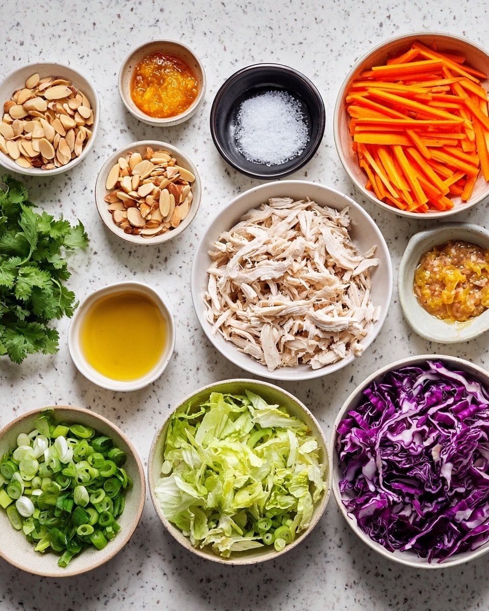 The image shows many small bowls arranged on a white marbled surface, each filled with different ingredients for a dish. There is one medium bowl in the middle with shredded white chicken. To the right, a white bowl holds thin bright orange carrot sticks, and next to it is a dark bowl filled with chopped purple cabbage. Below, a bowl with shredded light green lettuce sits next to a white bowl of sliced green onions. On the left side, a white bowl is full of sliced almonds, and beside it are fresh green cilantro leaves. Other small bowls contain golden liquid, a creamy orange paste, minced garlic, sliced fried onions, and a small black bowl with white salt. The ingredients are neatly placed, showcasing a colorful mix of textures and fresh colors—photo taken with an iphone --ar 4:5 --v 7