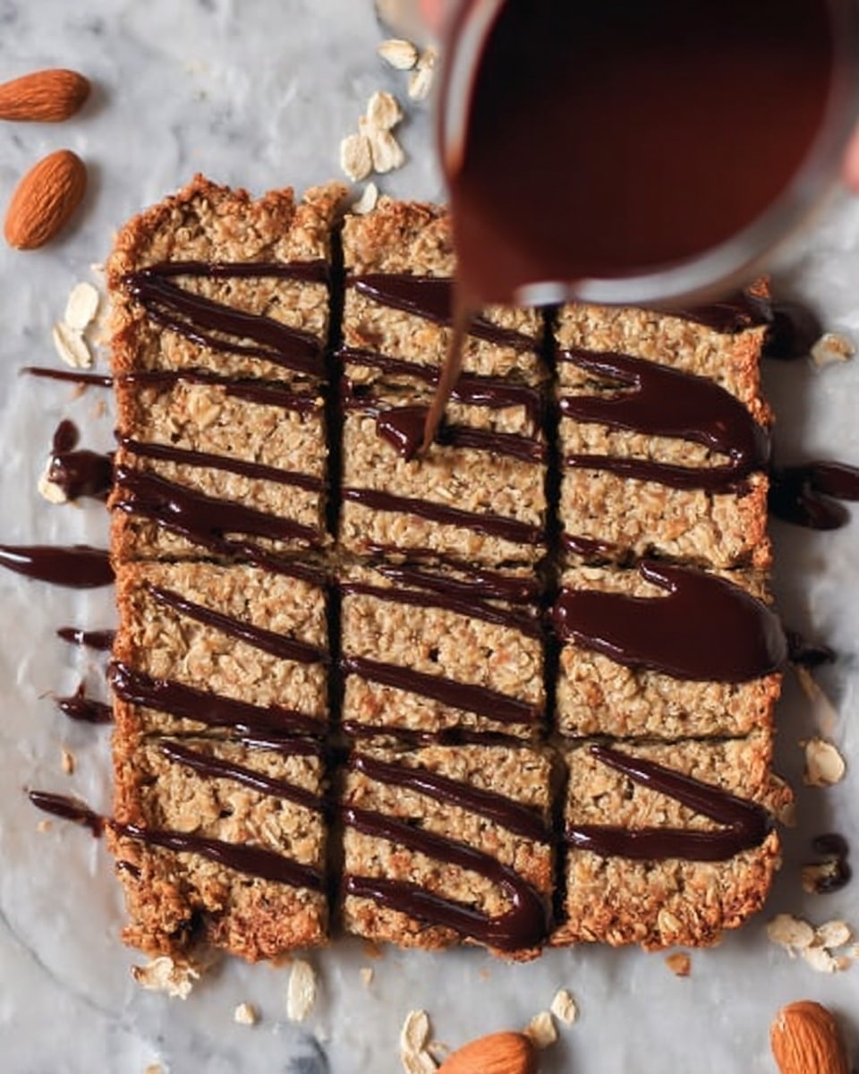 A square oat bar dessert cut into eight even rectangles rests on parchment paper over a white marbled surface. The oat bars have a light brown, crumbly texture, with visible oats embedded in the baked layer. Dark, glossy chocolate sauce is being drizzled in thick, uneven lines across the bars from the top left, adding a rich contrast to the oat color. A woman's hand holds the container pouring the chocolate from the upper left corner. Scattered oat flakes and almonds are around the bars. photo taken with an iphone --ar 4:5 --v 7