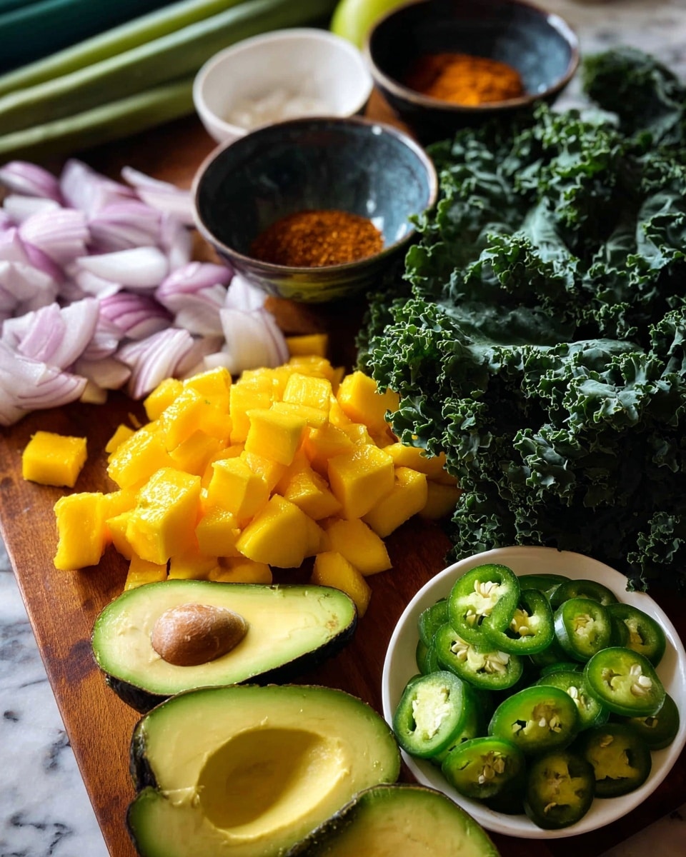 The image shows a wooden board filled with fresh ingredients laid out in layers. The front layer has a few halves of dark green avocados with smooth, creamy green insides. Just behind and slightly to the right, there are bright yellow chunks of mango in small square pieces, stacked closely together. To the left of the mango chunks, there are thin slices of pale purple shallots spread out. Toward the back, a white bowl holds a reddish-brown spice powder on the left side, while on the right, a dark bowl contains chopped light green cucumber pieces. In front of the shallots, a white plate holds several round slices of green jalapeño peppers, sprinkled with salt. Behind all these ingredients, large dark green leafy kale stretches across the board. The setting is on a white marbled surface, photo taken with an iphone --ar 4:5 --v 7