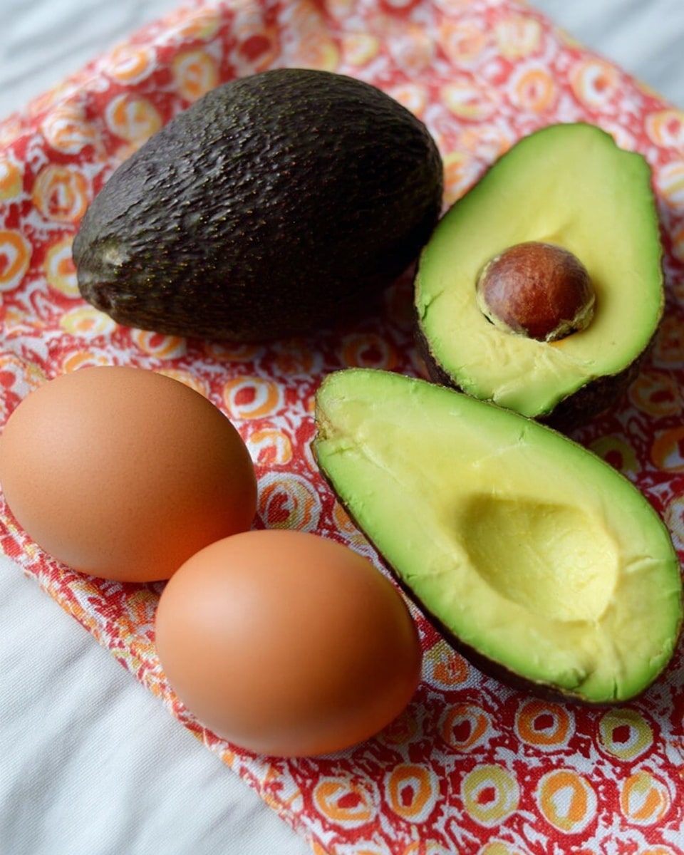 The image shows two whole brown eggs placed side by side on a white marbled surface with a red, orange, and white patterned cloth underneath. To the left of the eggs is a whole avocado with a dark, rough skin, and in front of it is a halved avocado showing smooth, bright green flesh with a creamy texture and no seed. To the right of the eggs is another halved avocado showing its green flesh and a brown seed in the center. The colors contrast nicely against the white marbled surface and colorful cloth photo taken with an iphone --ar 4:5 --v 7