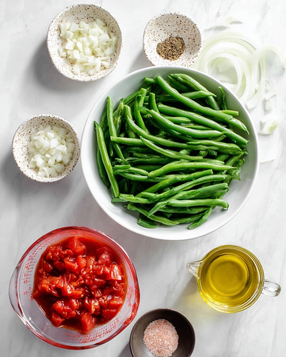A white bowl filled with many fresh green beans sits on a white marbled surface. Nearby, a small white bowl holds chopped garlic, a white bowl with thinly sliced white onions, and a small speckled white dish with brown and red spices and salt. There is a glass measuring cup full of bright red tomato chunks and another small clear container with golden olive oil. A small dark dish contains mixed black pepper and pink salt. Everything is spread out with a soft natural light. photo taken with an iphone --ar 4:5 --v 7
