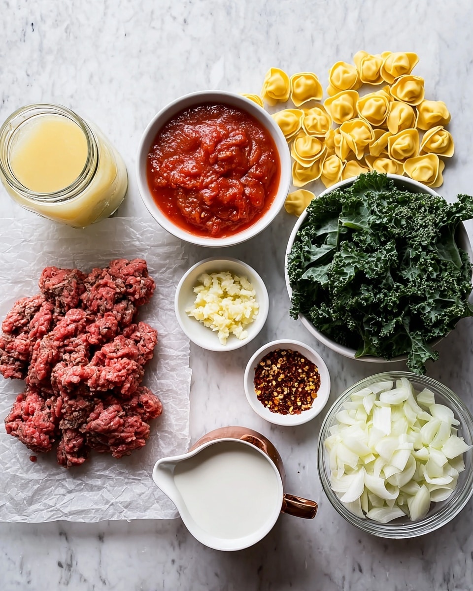 The image shows a spread of cooking ingredients arranged neatly on a white marbled surface. Starting from the left, there is a glass jar filled with a light yellow liquid, next to it is a white bowl with chunky red tomato sauce. Below that, raw ground meat is placed on a piece of parchment paper, showing its rough texture and deep red color. Above the meat, there is a small white bowl filled with minced garlic. To the right of the garlic, uncooked yellow tortellini are scattered. Near the middle, a small white cup with a copper handle holds a white creamy liquid. Below that, a small white plate has red chili flakes. To the right, a clear glass bowl is filled with white chopped onions, and a large white bowl on the far right contains chopped dark green leafy kale. All items are shown clearly from above, with natural light enhancing the fresh and vibrant colors photo taken with an iphone --ar 4:5 --v 7