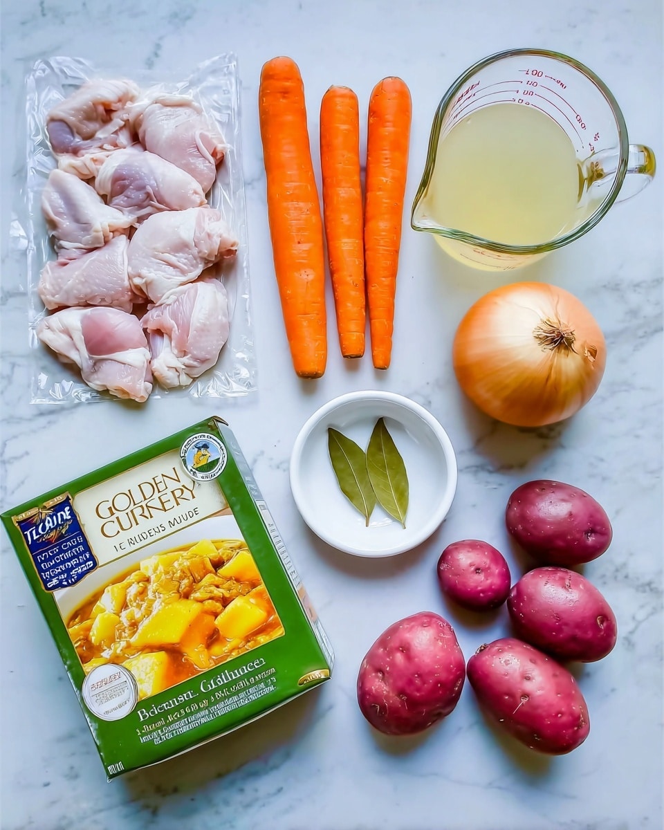 The image shows ingredients laid out for a meal on a white marbled surface, arranged neatly in rows. There is a clear plastic pack of raw chicken pieces at the top left, next to three bright orange carrots on the right. Below the chicken, there is a whole yellow onion and next to it a small white bowl holding a green bay leaf. In the center bottom is a green and yellow box labeled