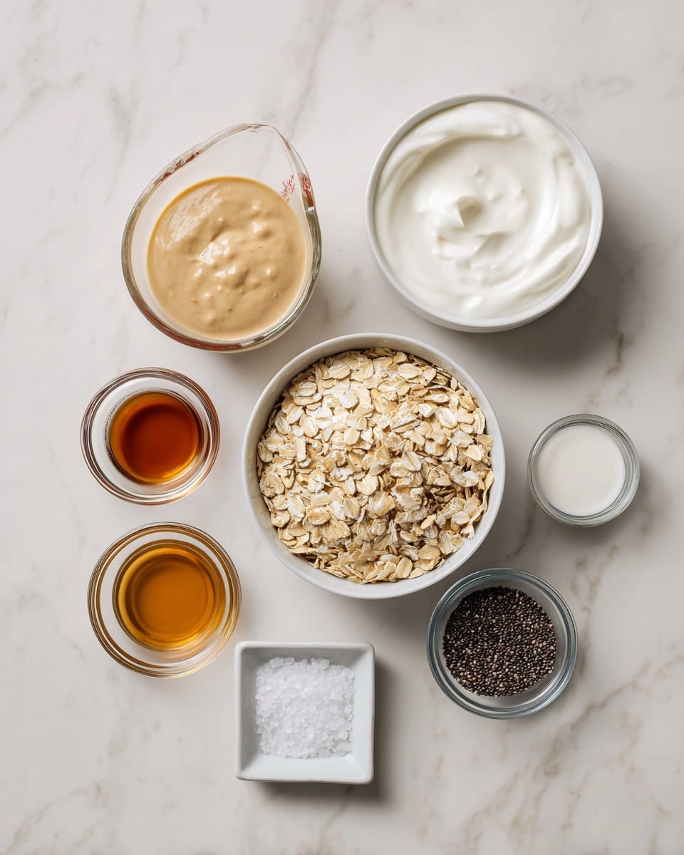 The image shows eight small bowls and a measuring cup placed on a white marbled surface. In the center is a white bowl filled with light beige rolled oats. To the top right is a white bowl with smooth, white yogurt. Below that, a small clear glass bowl holds a beige thick paste. Around these, smaller clear glass bowls contain different ingredients: one dark amber liquid, one light brown liquid, one containing small black chia seeds, and one clear liquid. In the bottom center, a small white square dish contains a bit of salt. At the top left, a translucent measuring cup is filled with a creamy light beige liquid. photo taken with an iphone --ar 4:5 --v 7