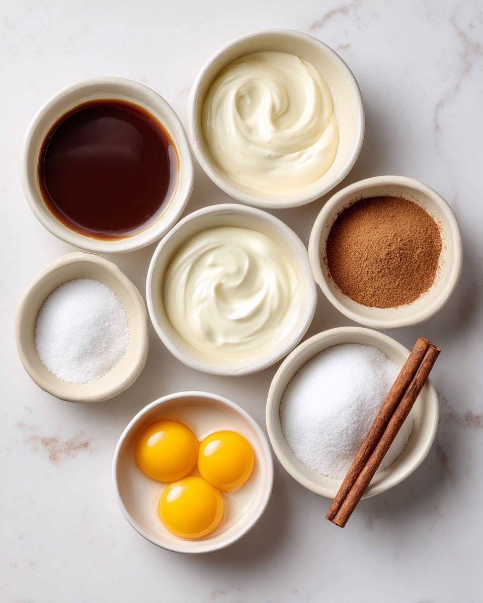 Seven small white bowls stand on a white marbled surface arranged in two rows; the back row has a bowl of dark brown vanilla liquid on the left, a bowl of thick white heavy cream in the center left, a bowl of smooth white half & half cream in the center right, and a bowl of light brown cinnamon powder on the right. The front row has a bowl of fine white salt on the left, a bowl with two bright yellow egg yolks in the center left, a bowl filled with white granulated sugar in the center right, and a bowl holding a brown cinnamon stick labeled optional on the right. Each bowl's contents show clear textures and colors, with labels in black text overlay. Photo taken with an iphone --ar 4:5 --v 7