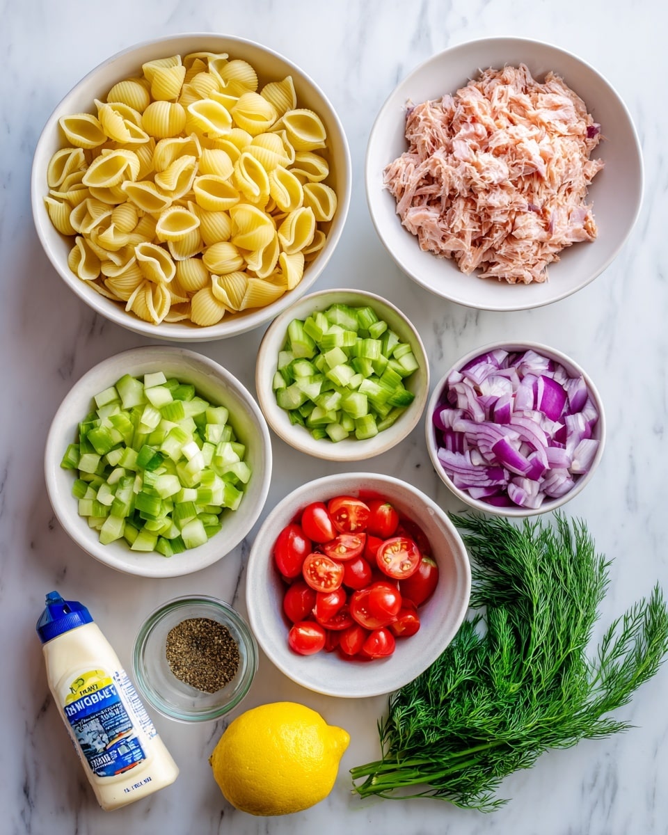 The image shows seven white bowls and items arranged neatly on a white marbled surface. The largest bowl is filled with yellow uncooked shell pasta at the bottom left. Above that is a bowl with light pink tuna flakes. To the right of the tuna is a large bowl with four sections of bright red cherry tomatoes, light green celery, purple-red chopped red onion, and fresh green cucumber pieces. Below these is a small white bowl of green diced pickles. Nearby are a whole yellow lemon, a small glass bowl with brown pepper and celery salt, a bunch of fresh green dill, and a white bottle of mayonnaise with a blue label. All items are bright and clear. Photo taken with an iphone --ar 4:5 --v 7